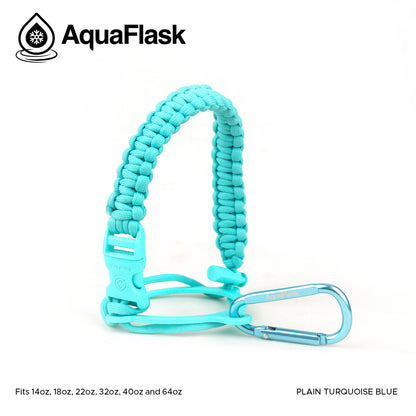 Accesorio de asa de paracord Aquaflask presentado sobre un fondo blanco con el logotipo de Aquaflask. El accesorio está fabricado con paracord firmemente tejido que forma un asa corta. Incluye una hebilla plástica de liberación lateral, un lazo ajustable que se coloca alrededor del cuello de la botella y un mosquetón metálico negro para su sujeción. El producto está etiquetado como compatible con botellas Aquaflask de 14 oz, 18 oz, 22 oz, 32 oz, 40 oz y 64 oz.